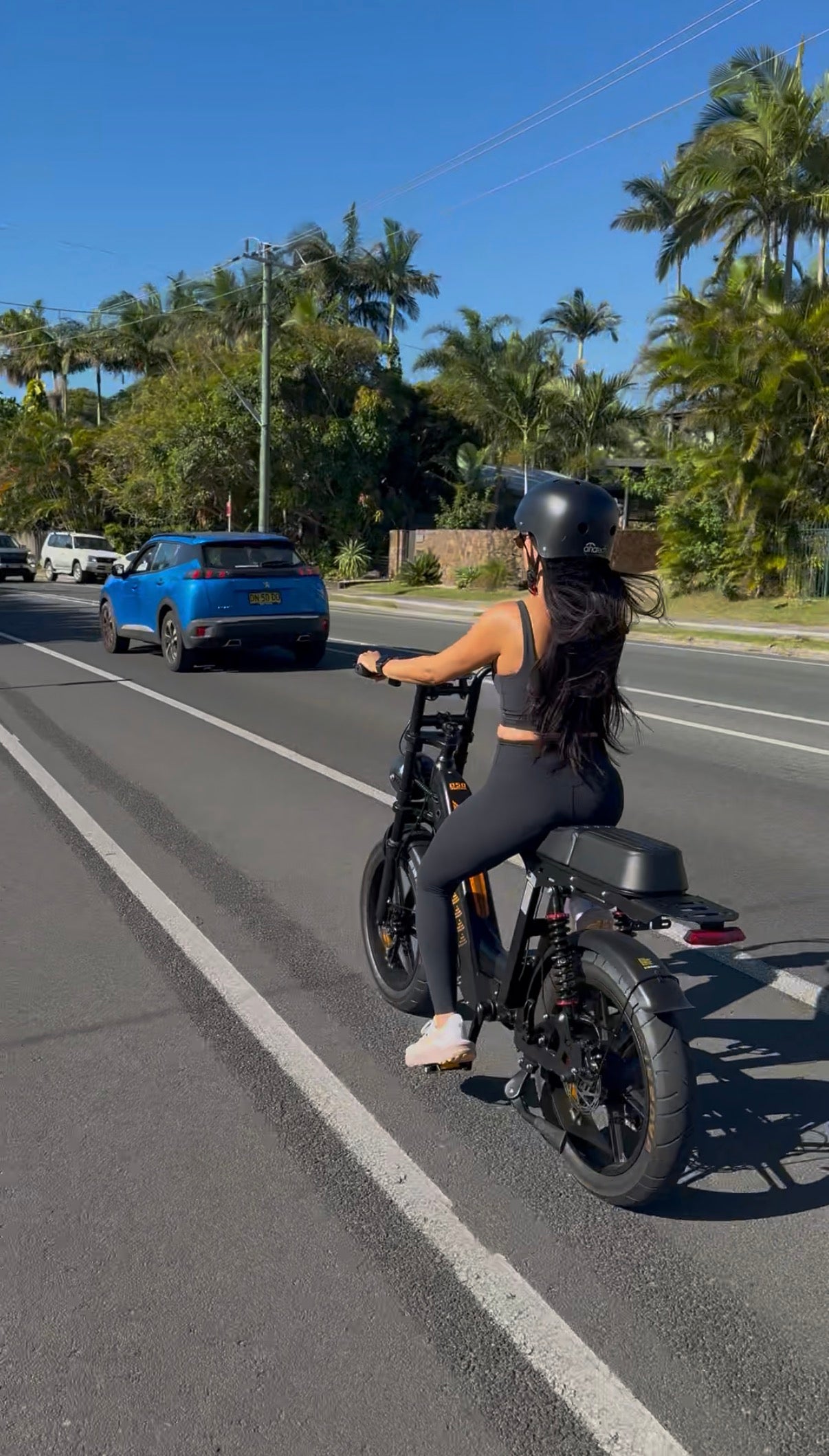 Woman riding an electric bike on an Australian road